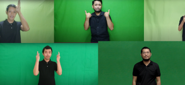 a man in a black shirt and a green screen