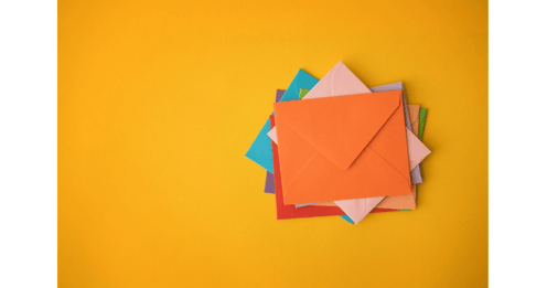Stack of colorful envelopes on yellow background | Email marketing concept