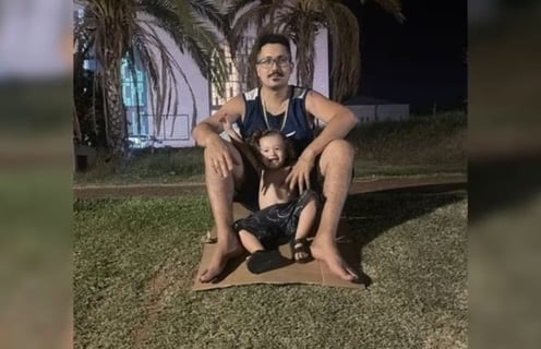 a man sitting on a mat with a child