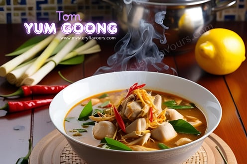 A bowl filled iwth Tom Tum Goong, slong with onion and lemons