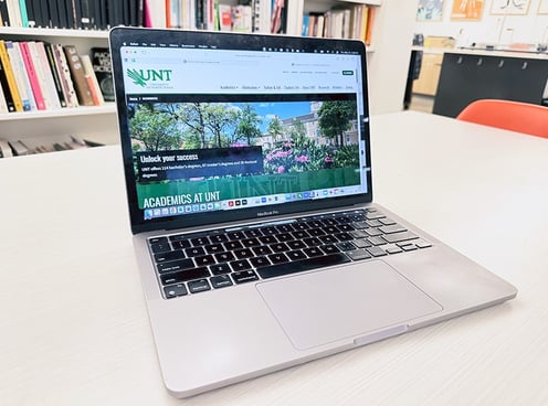 Image of a laptop opened to a University of North Texas web page.