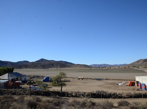 Image of Little Liberia farmlands in 2022. Picture of farm with hills in the background.