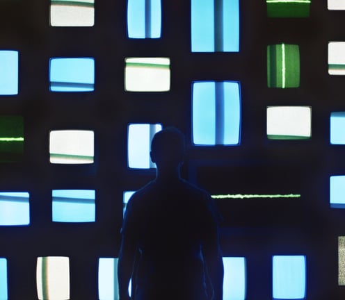 a man standing in front of a wall with multiple colored squares