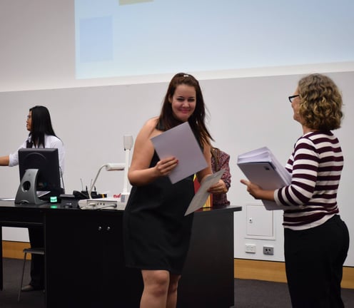 Picture of me receiving a certificate from a QUT tutor