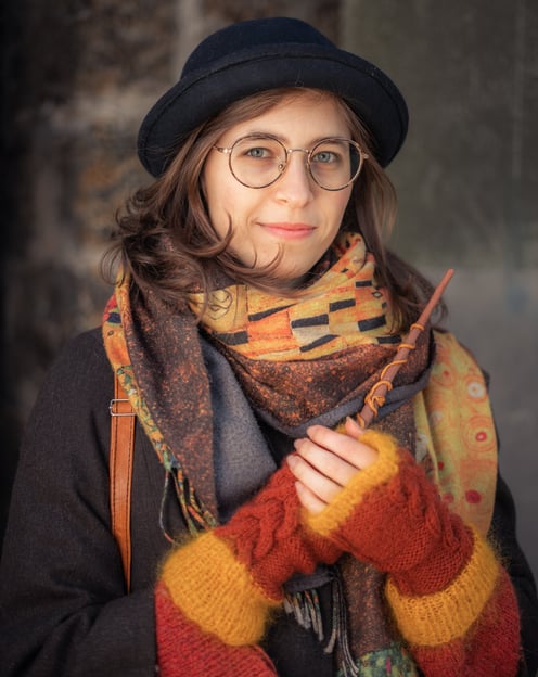 a woman in a hat and scarf around her neck