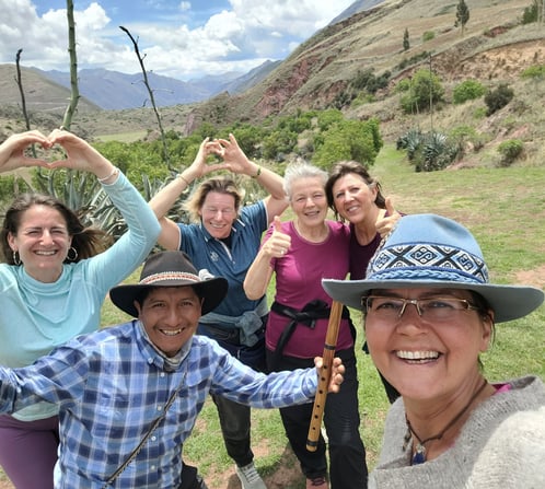 a group of people standing infront of the south gate of Cusco Valley