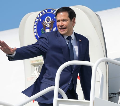 a man in a suit and tie is walking up stairs