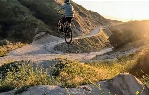 A mtb rider hitting a big double jump