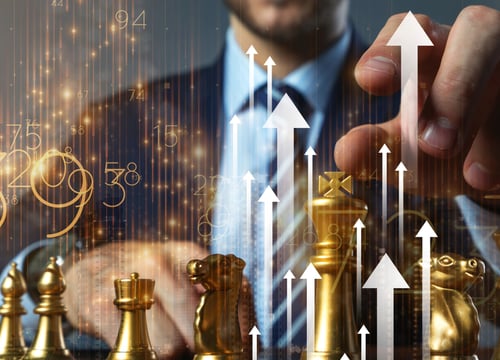 a man in a suit and tie is holding a chess piece, a picture demonstrating business strategy