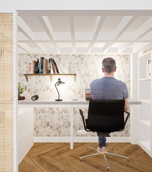 un homme qui travaille à son bureau sous un lit mezzanine