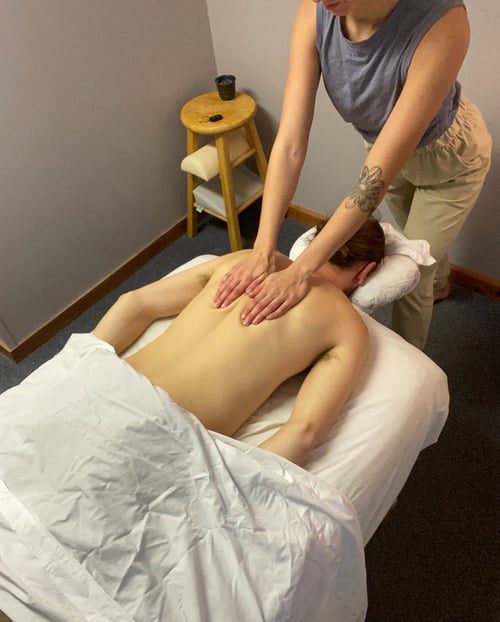 a person getting a massage by a Massage Therapist