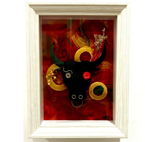 a picture of a bull headdressuck with a red background
