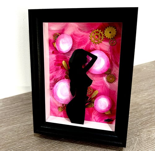 a picture of a woman silhouetted against a pink flower