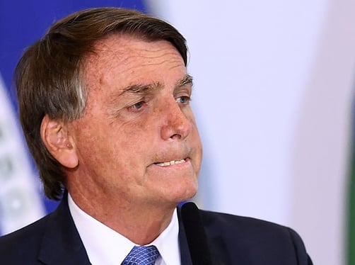 a man in a suit and tie is looking at something