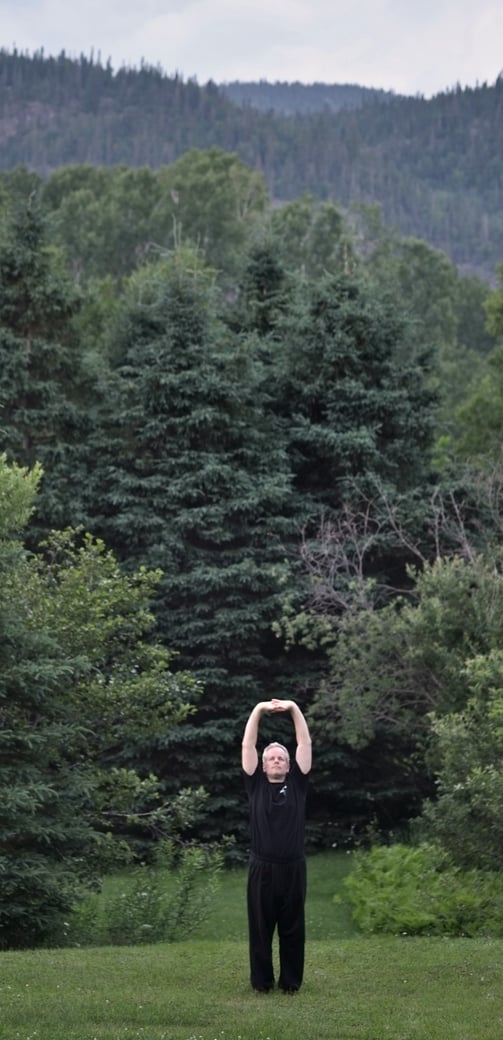 Forest landscape with man stretching