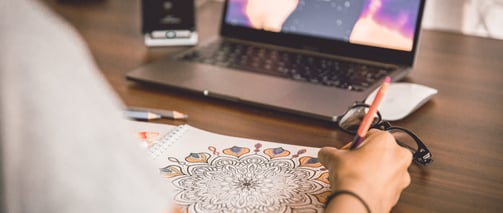 Mandala page book is colouring by a person