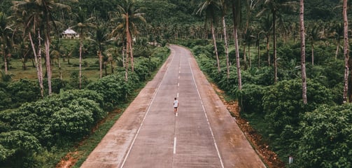 a person riding a bike down a road