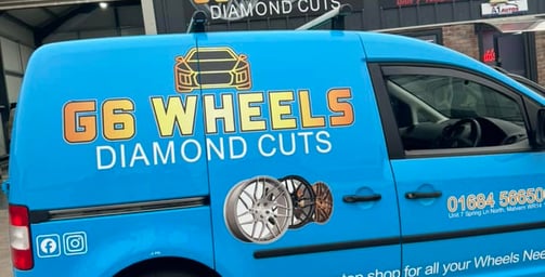 a blue van with a G6 wheels logo on the side