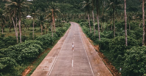 a person riding a bike down a road