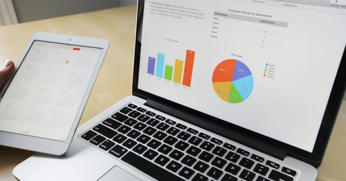 A laptop with data chart in screen.