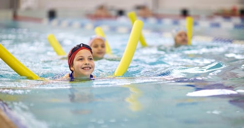 young child learning to swim