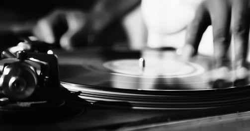 a person is playing a record on a record player