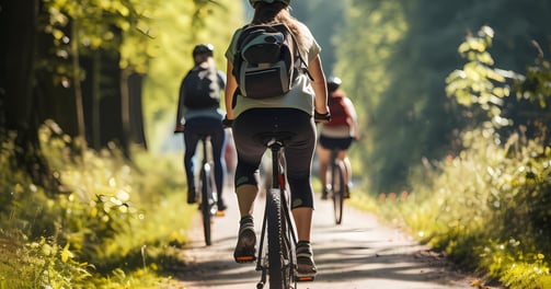 a group of people riding bikes down a path