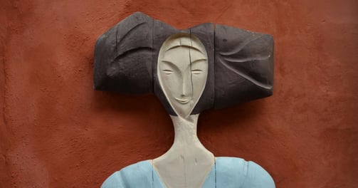 a woman's head and shoulders in wood