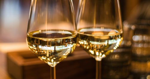 two wine glasses with wine glasses on a table