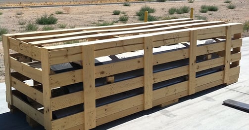 an open crate with plywood slats