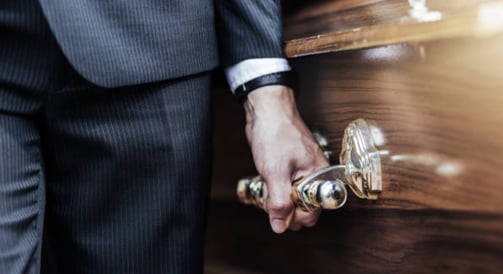 a close up of a pall bearer holding a coffin's handle