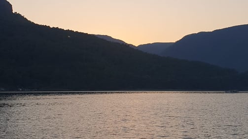 a boat is sailing on the water at sunset