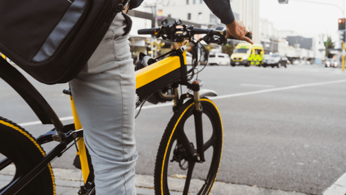 a person riding a bike on a city street