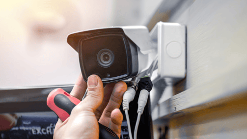 a person holding a camera and a camera