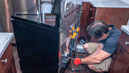 a man in a kitchen with a refrigerator and a refrigerator