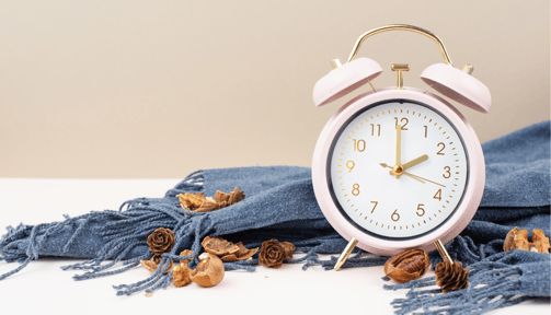 a pink alarm clock sitting on a table