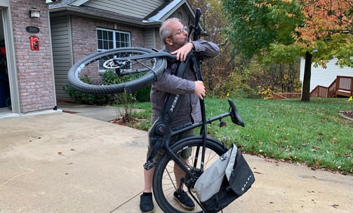 Jesse Estevez holding up his bike vertically to kiss it