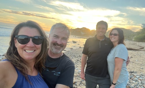 a group of people standing on a beach