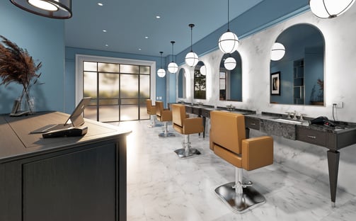 Luxury barbershop fit-out: deep blue walls, white marble floors, custom timber furniture, and lights