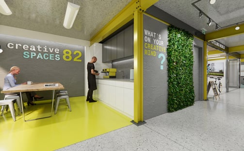 Industrial commercial space: concrete floors, exposed metal columns & beams, yellow features paint