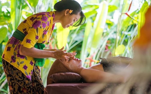 a woman getting a facial massage at a spa
