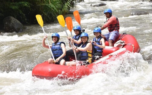 a group of people on raft raft rafting down a river