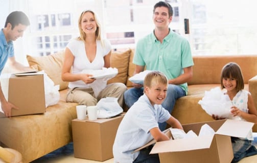 a family moving boxes in a living room