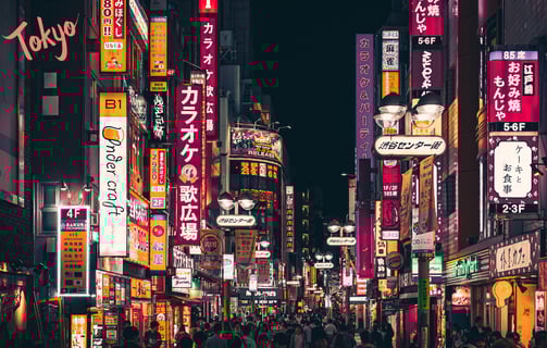 a city street scene with a lot of people walking down the street in Tokyo