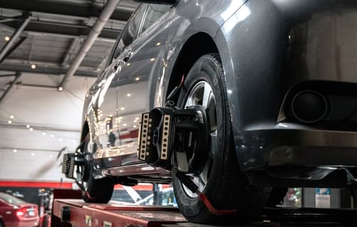 car undergoing wheel balancing and alignment