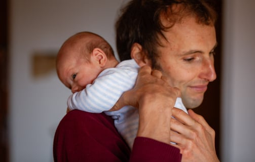 a man holding a baby in his arms
