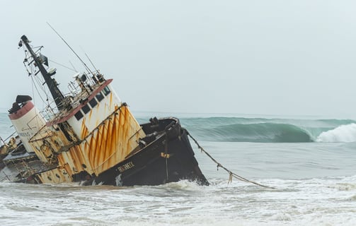 Shipwreck with perfect wave rolling on the back