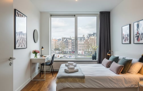 Spacious and bright bedroom in a modern Amsterdam apartment, offering comfort