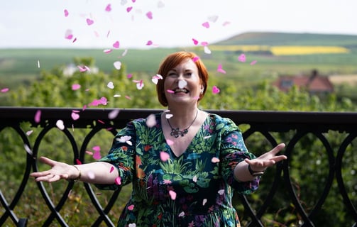 Celebrant throwing wedding confetti