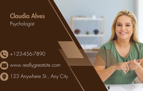 a woman sitting at a table with a business card